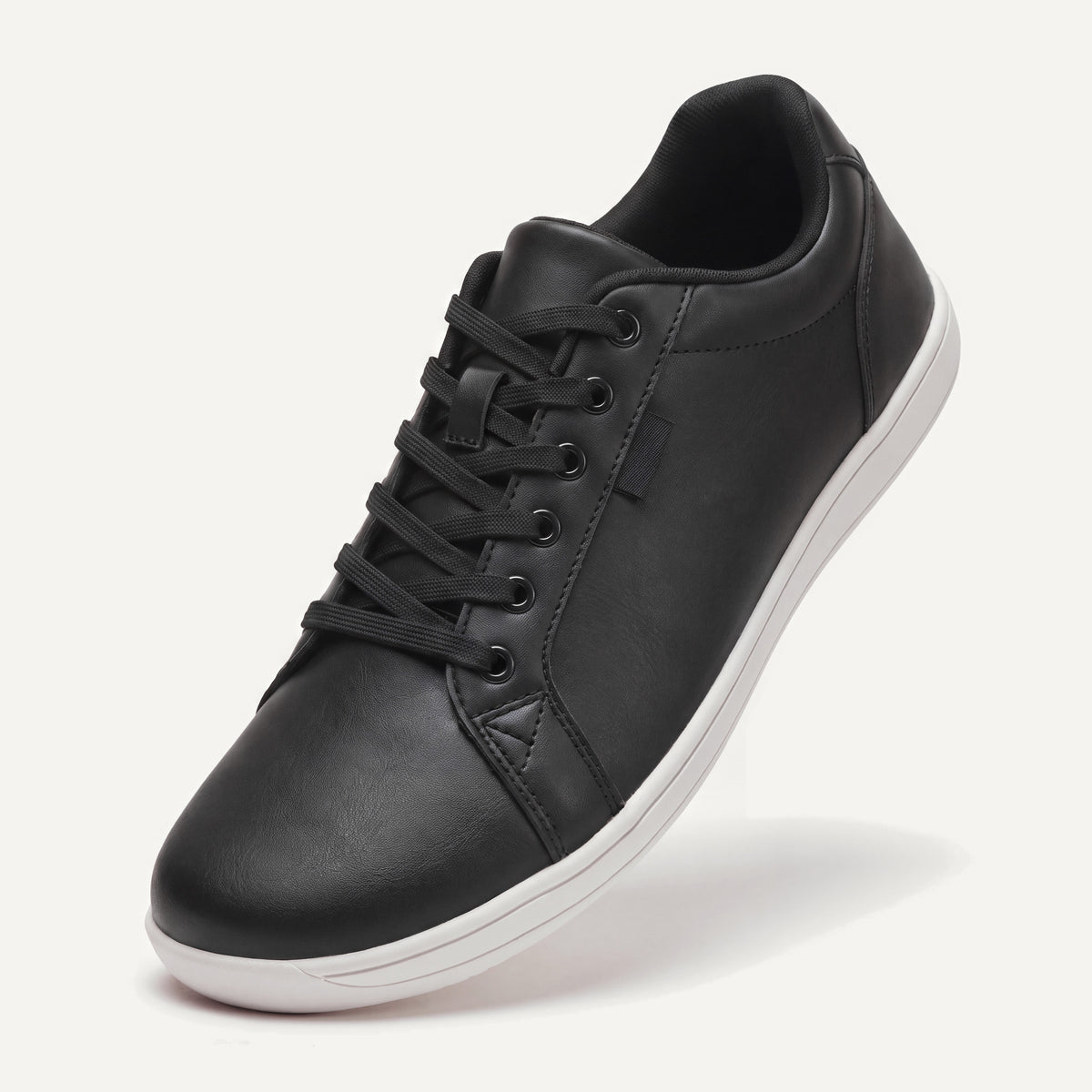 Pelle Vie in Classic (black upper, white sole), standing on the toe, top view of the laces